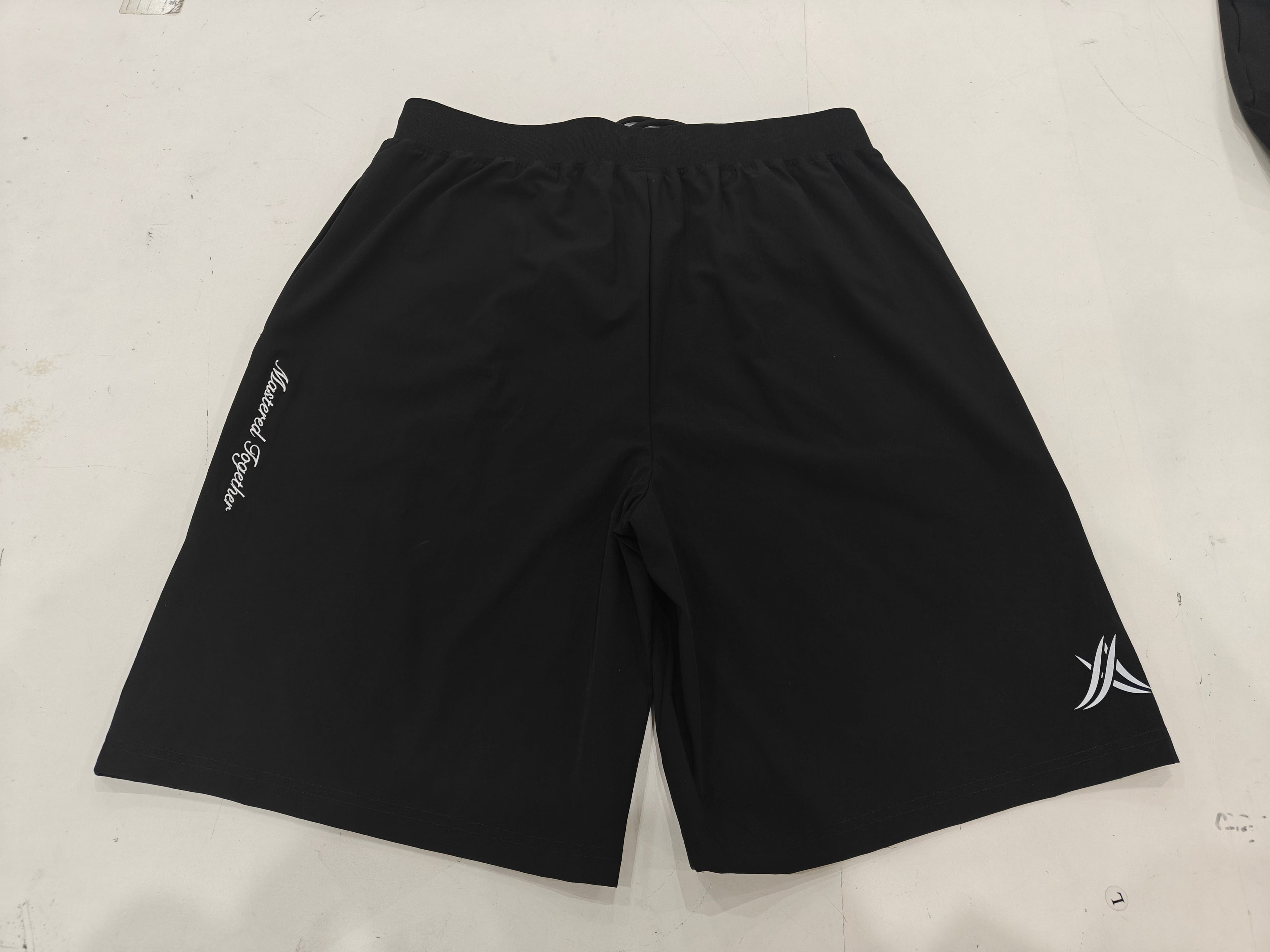 Back view of black 'Mastered Together' shorts