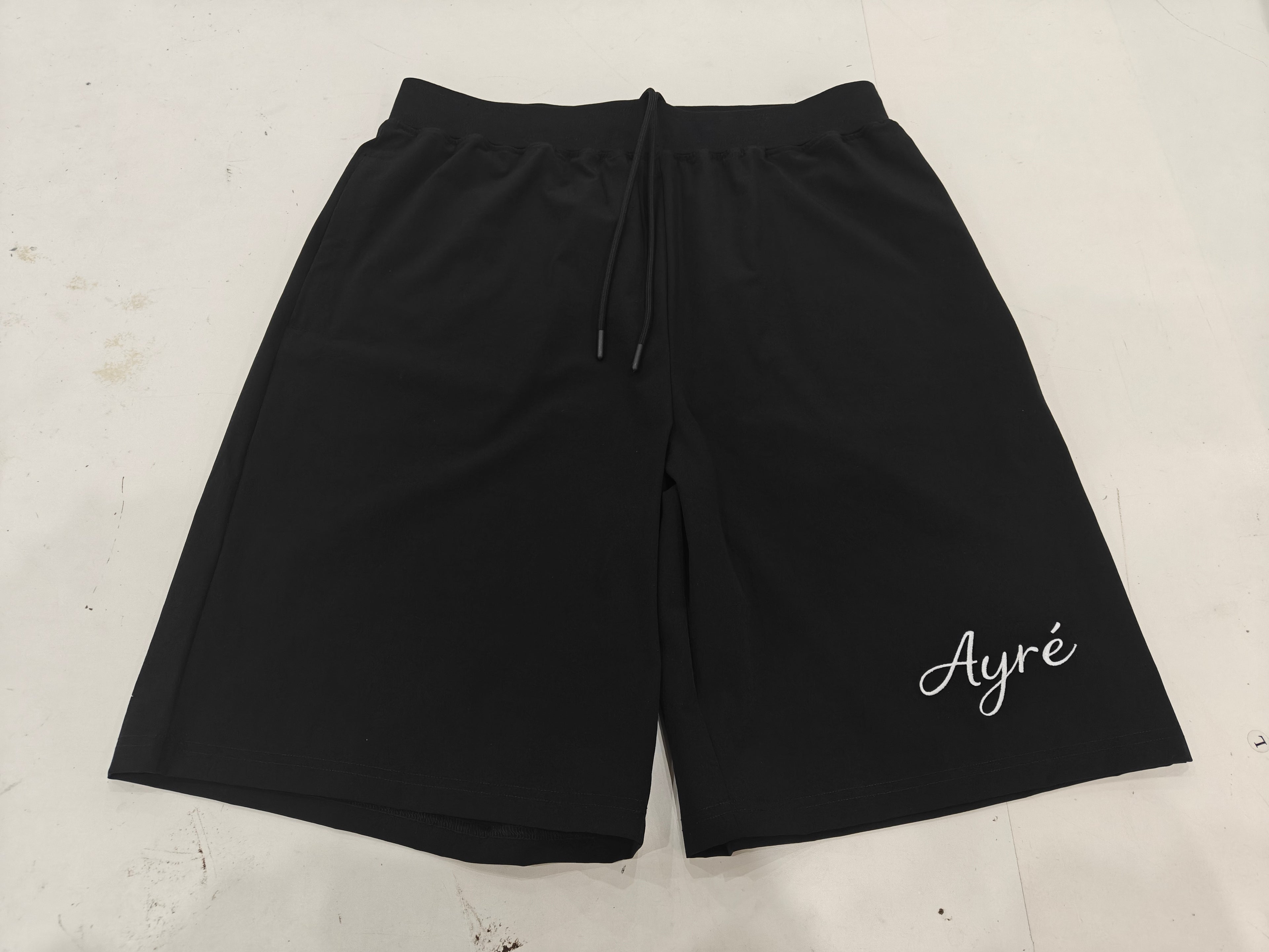Front view of black 'Mastered Together' shorts